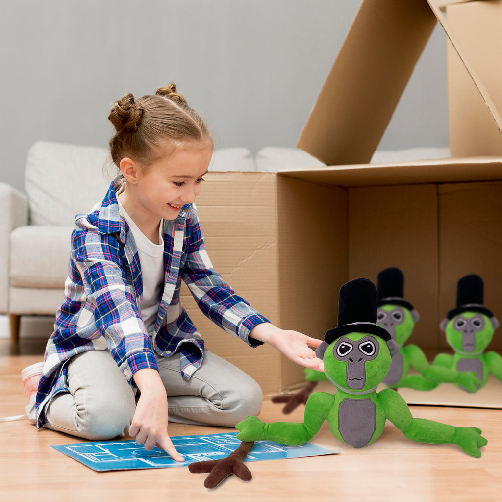 Girl playing on the floor with a green long arm monkey plush beside a cardboard fort
